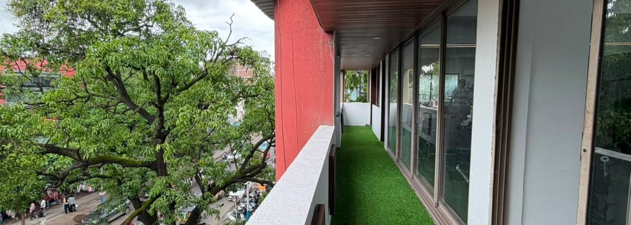 The first-floor walkway running along the front of the building above FC Road